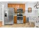 Bright kitchen featuring stainless steel appliances, light-colored countertop, and an eat-in table set at 303 Sylvias Ct, Durham, NC 27703