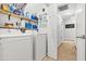 Laundry room with modern washer and dryer, storage shelves, and access to the hallway at 303 Sylvias Ct, Durham, NC 27703