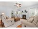 Comfortable living room featuring a fireplace, ceiling fan, hardwood floors and plenty of seating at 303 Sylvias Ct, Durham, NC 27703