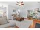 Bright living room featuring hardwood floors, a ceiling fan, and an inviting seating arrangement at 303 Sylvias Ct, Durham, NC 27703