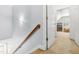 Upstairs hallway features a wood handrail, fresh paint, carpet, and access to a bonus room at 303 Sylvias Ct, Durham, NC 27703