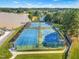 Aerial view of the community's tennis, basketball courts, and playground equipment, with the lake in the background at 303 Sylvias Ct, Durham, NC 27703
