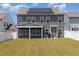 Home exterior with solar panels and a screened porch, overlooking a large, green backyard at 311 Horseshoe Pl, Angier, NC 27501