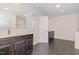 Bathroom featuring double sinks, modern fixtures, and stylish dark hexagon tile floor at 311 Horseshoe Pl, Angier, NC 27501