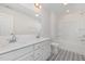 Bathroom featuring double sinks, modern fixtures, and stylish white vanity at 311 Horseshoe Pl, Angier, NC 27501