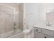 Bathroom featuring a tiled shower, a gray vanity with modern fixtures, and neutral tones at 311 Horseshoe Pl, Angier, NC 27501