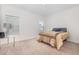 Neutral bedroom with carpet floors, side table, and natural light from multiple windows at 311 Horseshoe Pl, Angier, NC 27501