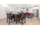 Bright and airy dining area adjacent to a modern kitchen with an island and stainless appliances at 311 Horseshoe Pl, Angier, NC 27501
