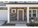 Inviting front porch with stone accents and a stylish front door, perfect for welcoming guests at 311 Horseshoe Pl, Angier, NC 27501