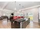 Open-concept kitchen with a central island, modern appliances, and seamless access to the living area at 311 Horseshoe Pl, Angier, NC 27501