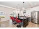 Modern kitchen with a large island, stainless steel appliances, and stylish pendant lighting at 311 Horseshoe Pl, Angier, NC 27501