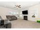 Cozy living room featuring a plush sectional sofa, fireplace, and a ceiling fan at 311 Horseshoe Pl, Angier, NC 27501