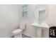 Stylish powder room with pedestal sink, decorative mirror, and patterned tile flooring at 311 Horseshoe Pl, Angier, NC 27501