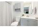 This bathroom offers a modern vanity, stylish mirror, a toilet, and a shower curtain at 318 Silverberry Ct, Cary, NC 27513