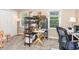 Bright bedroom featuring large windows, a storage rack, and an artist's painting station at 318 Silverberry Ct, Cary, NC 27513