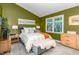 Cozy bedroom with green walls, carpeted floors, and a bright window at 318 Silverberry Ct, Cary, NC 27513