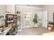 Cozy bedroom featuring a desk with shelves, cat tree, and a view of the ensuite bathroom and stairs at 318 Silverberry Ct, Cary, NC 27513