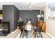 The dining room boasts hardwood floors, a modern light fixture, and a decorative fireplace at 318 Silverberry Ct, Cary, NC 27513