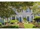 Charming townhomes featuring beautiful landscaping, front steps and gray siding at 318 Silverberry Ct, Cary, NC 27513