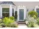 Close up of the front door showing beautiful landscaping, brick, and gray siding at 318 Silverberry Ct, Cary, NC 27513