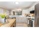 Open kitchen with stainless appliances, an island, and seamless transition to the other rooms at 318 Silverberry Ct, Cary, NC 27513