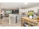 This kitchen features grey countertops, stainless appliances, and a view into an adjacent room at 318 Silverberry Ct, Cary, NC 27513