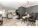 Open concept living space with dark accent wall, fireplace, dining area and living room at 318 Silverberry Ct, Cary, NC 27513