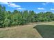 Large backyard with green grass, ready for landscaping, offering ample space for outdoor enjoyment at 325 Buckhorn Branch Park, Clayton, NC 27520