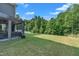 Spacious backyard with a covered patio area and lush greenery, perfect for outdoor activities at 325 Buckhorn Branch Park, Clayton, NC 27520