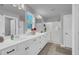 Bright bathroom featuring double vanity with white countertops, black hardware, and a glass enclosed shower at 325 Buckhorn Branch Park, Clayton, NC 27520