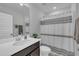Modern bathroom featuring a sleek vanity with ample countertop space and a stylish shower curtain at 325 Buckhorn Branch Park, Clayton, NC 27520