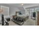 Bedroom with a bed, a futon and a TV with lots of natural light coming in from multiple windows at 325 Buckhorn Branch Park, Clayton, NC 27520