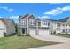 Attractive two-story house with a two-car garage and well-maintained lawn on a sunny day at 325 Buckhorn Branch Park, Clayton, NC 27520