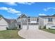 Well-kept two-story home with a two-car garage, lush lawn, and clear blue skies at 325 Buckhorn Branch Park, Clayton, NC 27520