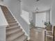 Welcoming foyer features a staircase, attractive console, and a tiled entrance with natural light at 325 Buckhorn Branch Park, Clayton, NC 27520