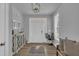 Bright foyer with hardwood floors, modern light fixture, and a welcoming white door at 325 Buckhorn Branch Park, Clayton, NC 27520