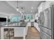 Bright kitchen features stainless steel appliances, a large island with seating, and an open floor plan at 325 Buckhorn Branch Park, Clayton, NC 27520