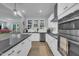 Well-lit kitchen showcasing white cabinets, stainless steel appliances, and dark countertops at 325 Buckhorn Branch Park, Clayton, NC 27520