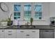 Kitchen sink area featuring modern fixtures, natural light, and white subway tile backsplash at 325 Buckhorn Branch Park, Clayton, NC 27520