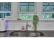 A well lit kitchen featuring a stainless steel sink and a view out the window at 325 Buckhorn Branch Park, Clayton, NC 27520