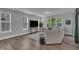 Bright living room with large windows, neutral tones, and modern furnishings at 325 Buckhorn Branch Park, Clayton, NC 27520