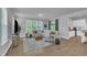 Open living room with hardwood floors, modern decor, and an adjacent kitchen area at 325 Buckhorn Branch Park, Clayton, NC 27520