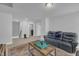 Upstairs living room with comfortable blue leather sofa, wooden table, and neutral walls at 325 Buckhorn Branch Park, Clayton, NC 27520