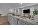 Spacious living area showcasing a comfortable sofa, dining area, and a large screen TV for entertainment at 325 Buckhorn Branch Park, Clayton, NC 27520
