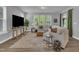 Inviting living room features a large sectional sofa, ample natural light, and stylish decor at 325 Buckhorn Branch Park, Clayton, NC 27520