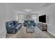 Upstairs living room featuring comfortable leather sofas, a large TV, and neutral tones at 325 Buckhorn Branch Park, Clayton, NC 27520