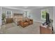 Spacious main bedroom featuring a tufted headboard bed, cozy seating area, and ample natural light at 325 Buckhorn Branch Park, Clayton, NC 27520