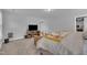 Comfortable main bedroom with TV, bed with floral pattern, and bright light from the windows at 325 Buckhorn Branch Park, Clayton, NC 27520