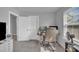 Bright home office with a comfortable chair, large windows and a functional desk setup for productivity at 325 Buckhorn Branch Park, Clayton, NC 27520