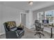 A relaxed home office space with a cozy chair, and modern desk setup with a view outside the windows at 325 Buckhorn Branch Park, Clayton, NC 27520